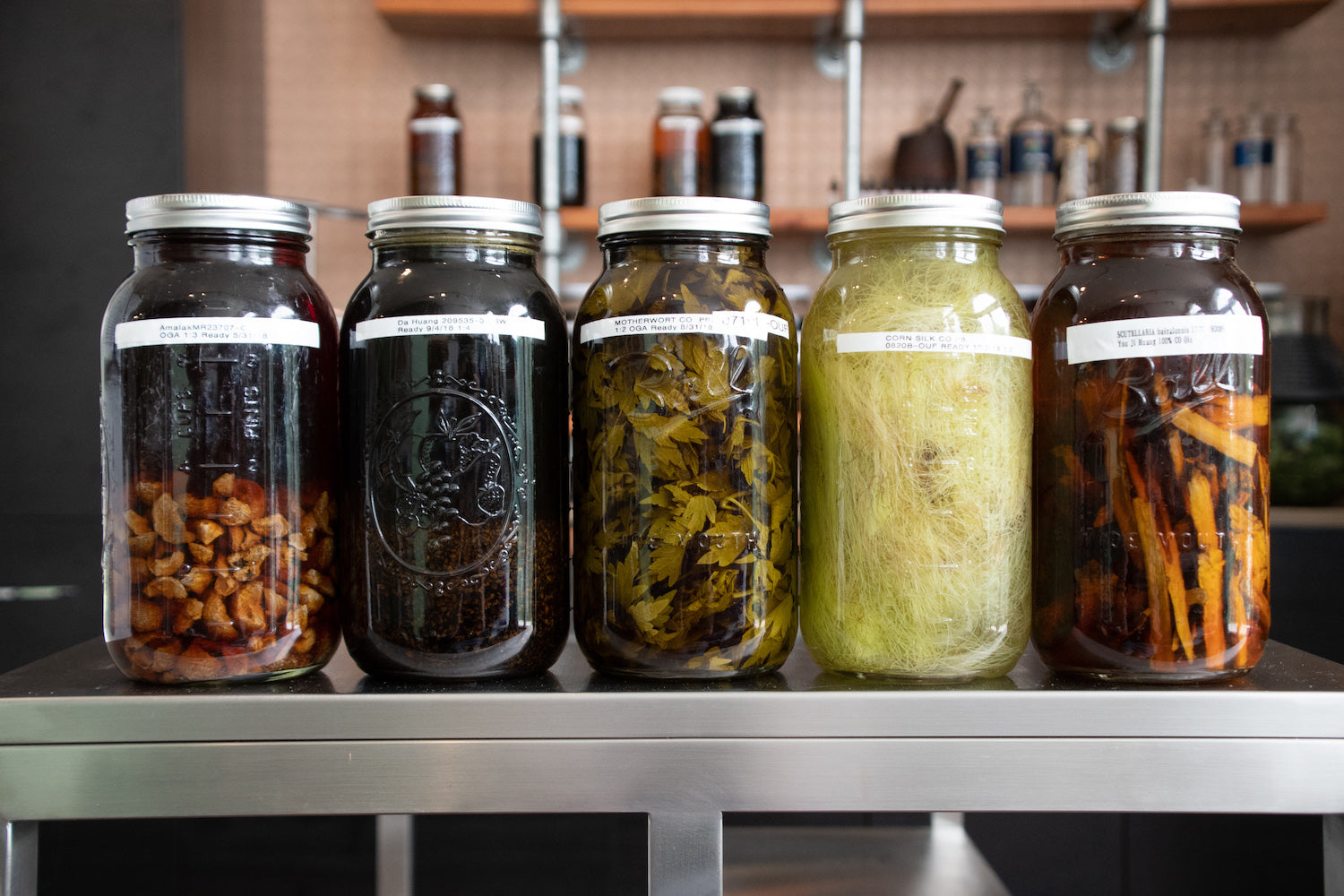 herbs being infused in jars